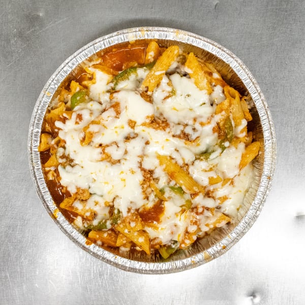 Baked penne pasta with melted mozzarella cheese, tomato sauce, and green peppers in a foil container.